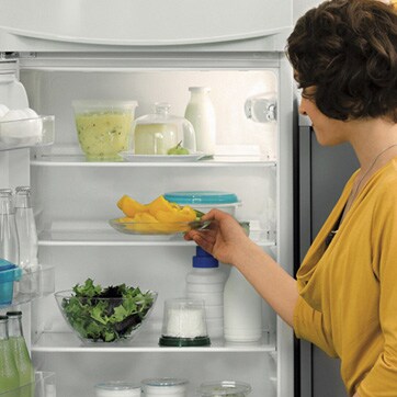 Woman opening fridge